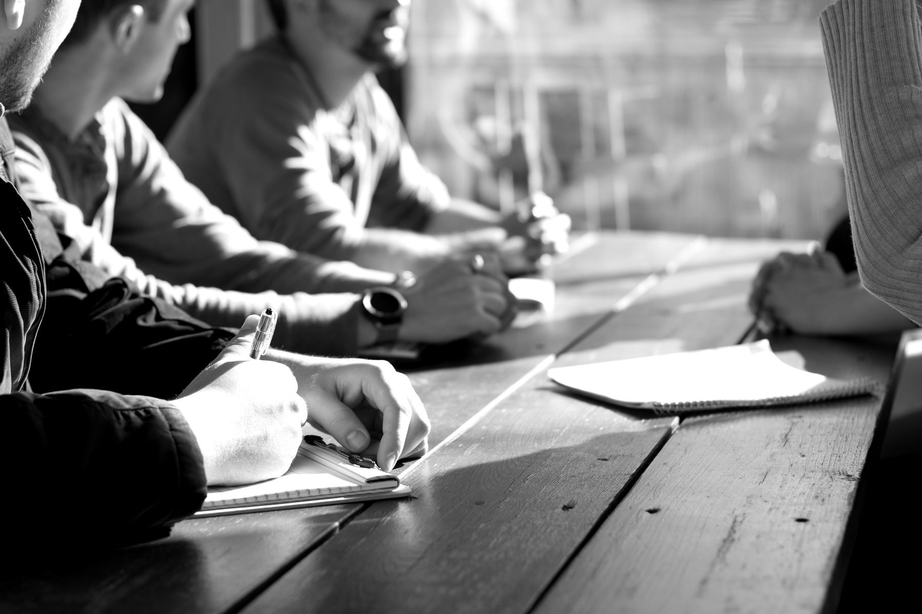 People taking notes around a meeting table
