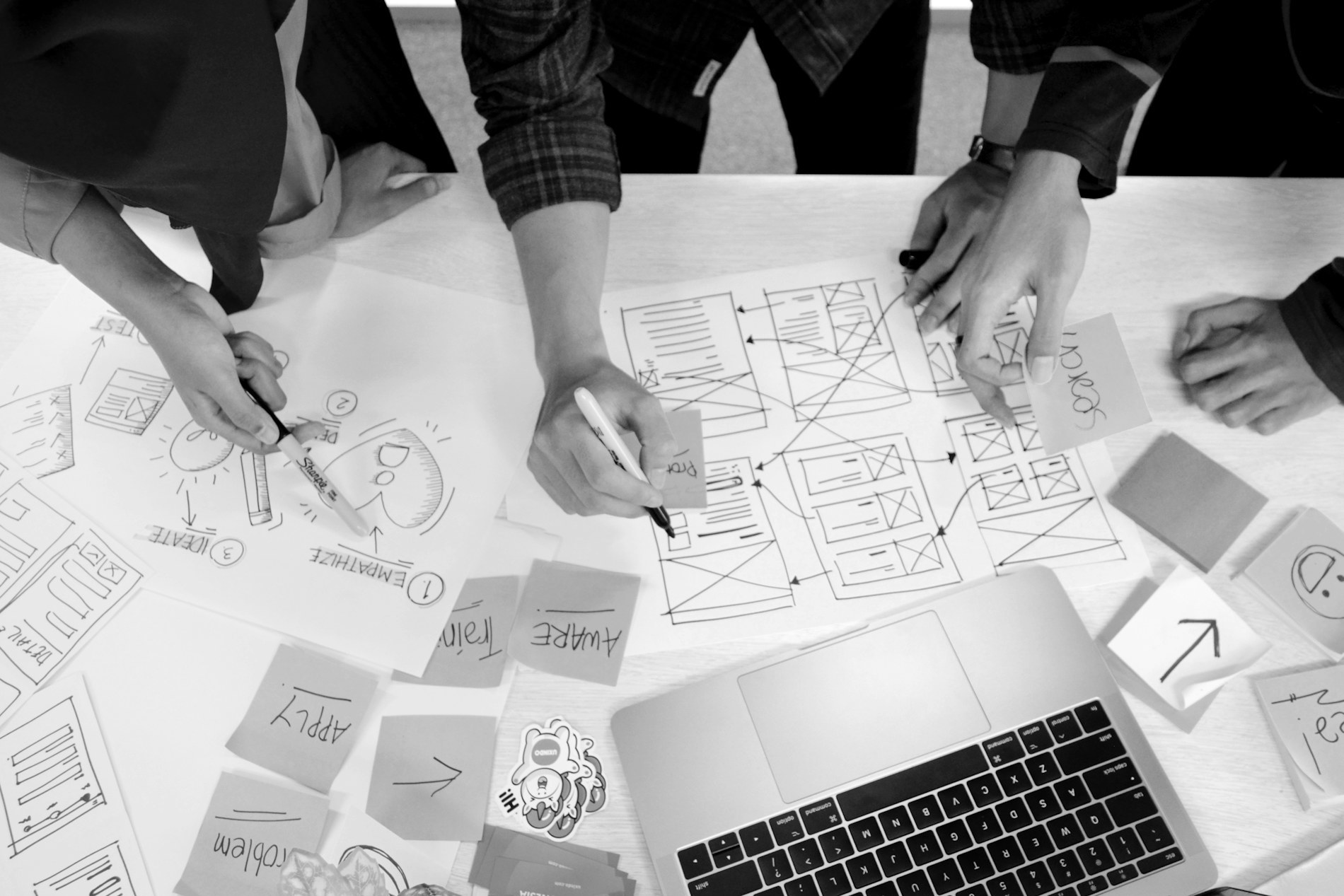 Website wireframes being sketched on paper