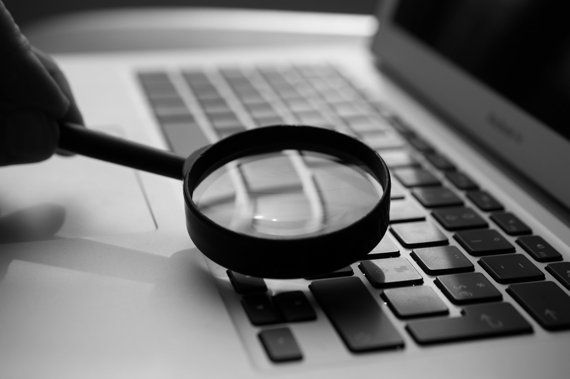 A magnifying glass over a laptop keyboard