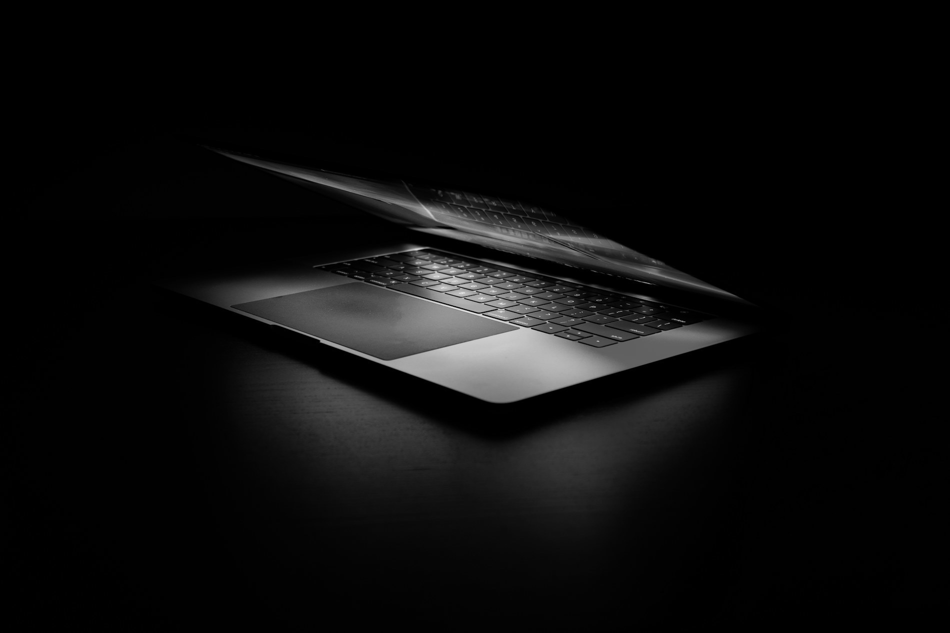 A laptop keyboard glowing in the dark